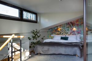 a bedroom with a bed with a mural on the wall at ArtSquare Fragola Apartments in Kraków