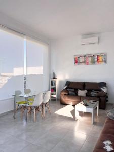 a living room with a couch and a table at El Coso Lodge & Workation in Zalamea la Real