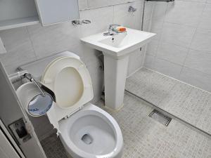 a bathroom with a toilet and a sink at Byeongjeom-yeok Stay 