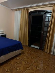a bedroom with a bed and a glass door at Sobrado lindo em Itú a 5 minutos do Centro ! in Itu
