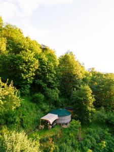 a gazebo in the middle of a hill with trees at Les songes du chêne in Augirein