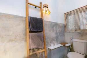a ladder in a bathroom with a toilet and a light at House Sawah - Beautiful & Stylish 3BR Home with Jacuzzi Near Umalas and Seminyak in Kerobokan +23 photos