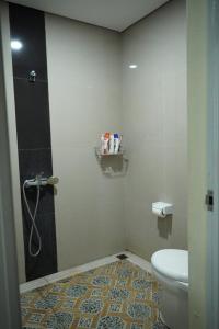 a bathroom with a shower and a toilet at Umah Desa in Banjarangkan