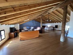 a large living room with wooden ceilings and wooden floors at Casa Rural La Quinta Del Poeta 
