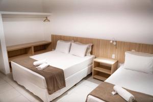 En eller flere senge i et værelse på Pousada Areia do Forte