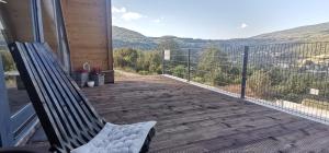 a bench sitting on a balcony with a view at Stone Chalets - LUNA in Jajce
