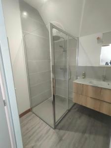 a bathroom with a glass shower and a sink at la ruée vers l'art 