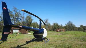 a blue and white helicopter parked in a field at Tiny Houses Casablanca in Casablanca