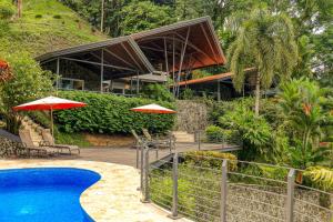 a resort with a swimming pool and chairs and umbrellas at Terrazas de Ballena in Uvita