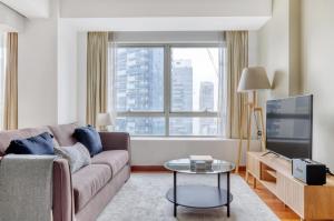 a living room with a couch and a tv at Splendid 1BR in Singapore in Singapore