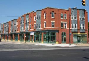a large red brick building on a city street at Downtown Cleveland -modern First Floor Unit in Cleveland