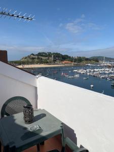 a table on a balcony with a view of a marina at Hotel Cais in Baiona