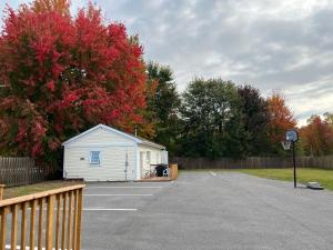 a small white building sitting in a parking lot at Lakeshore Suites in North Bay