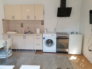 a kitchen with a washing machine and a stove at Apartments Old Town in Sarajevo