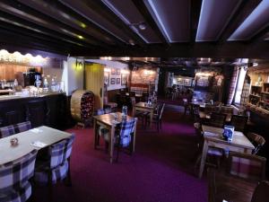 キャッスルトンにあるYe Olde Cheshire Cheese Innのテーブルと椅子のあるレストラン、バー