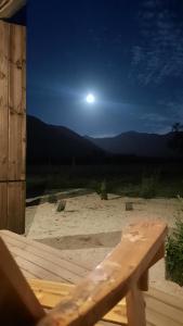 a view of the moon from a wooden bench at Tiny Houses Casablanca in Casablanca