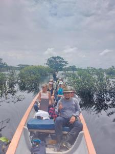 un groupe de personnes dans un bateau sur l'eau dans l'établissement WaitaAmazonlodge, 