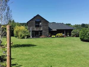 a house in a field with a grass yard at LA PAUSE in Surville