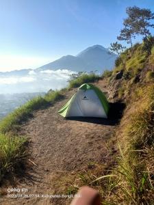 a tent sitting on the side of a hill at Gunung Batur camp in Kintamani
