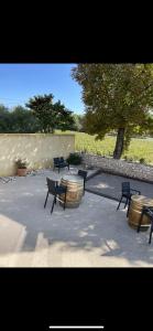 a group of chairs and a table and a barrel at Domaine de L'Olibaou in Venelles