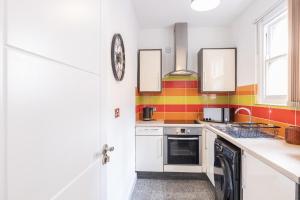 a kitchen with a sink and a stove top oven at The Olive Green Loft in Leicester