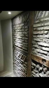 a stone wall in a room with a brick wall at Petite maison Liégeoise «la cabane de Liège» in Liège