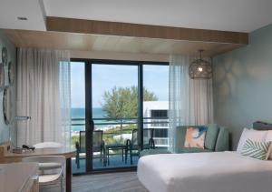 a hotel room with a bed and a view of the ocean at Zota Beach Resort in Longboat Key