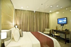 Postel nebo postele na pokoji v ubytování Goldberry Suites & Hotel Mactan