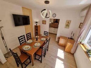 a dining room with a wooden table and chairs at Apartment in Crikvenica 5155 in Crikvenica