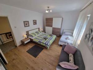 a small bedroom with a bed and a couch at Apartment in Crikvenica 5155 in Crikvenica