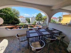 a table and chairs on a balcony with a view at Apartment in Crikvenica 5155 in Crikvenica