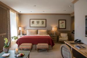 A bed or beds in a room at Gstaad Palace