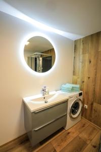 a bathroom with a washing machine and a sink at Bizon Village in Zalesie Górne +95 photos