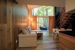 a living room with a couch and a table at Bizon Village in Zalesie Górne