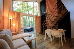 a living room with a couch and a table at Bizon Village in Zalesie Górne