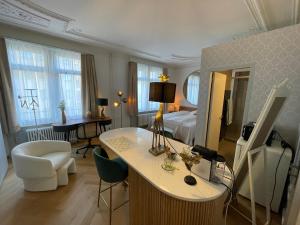 a hotel room with a bed and a table and chairs at Exclusive one room apartment next to Zürich main station in Zürich