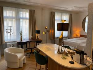 a hotel room with a bed and a desk and a bedroom at Exclusive one room apartment next to Zürich main station in Zürich