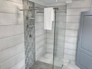 a bathroom with a shower with a glass door at Self-Catering at Cozy Comfort in Durban