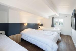 a bedroom with two beds and a television in it at DUNE, villa avec piscine et spa / Proche plage in La Couarde-sur-Mer +13 photos