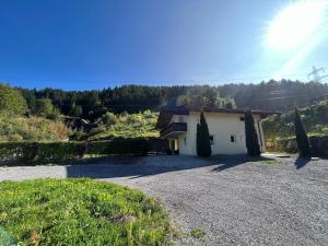 a small white house with a gravel driveway at Naturerlebnis am Glungezer-Haus-8 Pax in Tulfes