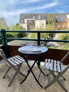 een tafel en 2 stoelen op een balkon bij Wild Berry, oasis de tranquilité pour 4 personnes in Le Crotoy
