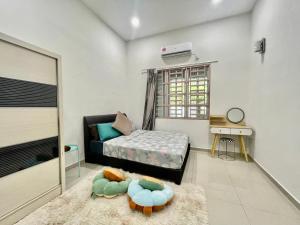 a living room with a couch and a bed at Home36#8pax#4bedroom#NearAeonAlma#Mcd in Bukit Mertajam