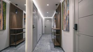 a hallway with doors and paintings on the walls at Apartments DREAM in Málaga