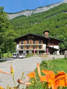 a large building in front of a mountain at Hôtel Le Choucas in Sixt