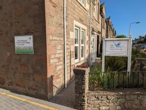 a brick building with signs on the side of it at The Ness Guest House in Inverness