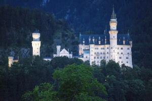 a castle sitting on top of a hill with two towers at Alpflower in Halblech