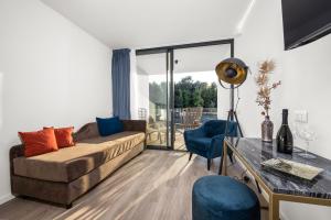 a living room with a couch and a table at Hotel Del Mar Emotion in Pula