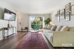 a living room with a couch and a tv at 12 Min to Airport Spacious Backyard and Fire Pit in Austin