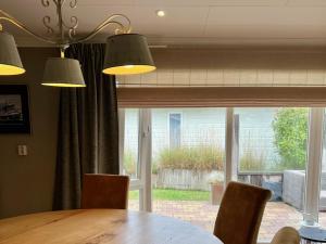 a dining room with a table and a large window at WHITE BEACH HOUSE in Breskens