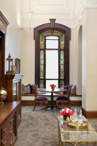 a living room with a table and chairs and a window at Celeste of St Paul in Saint Paul